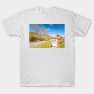 Honor system sign for tomatoes in rural New England beside an American style red barn by a river. T-Shirt